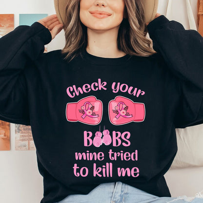 Teesdily | Check Your Boobs Mine Tries To Kill Me Shirt, Breast Cancer Sweatshirt, Cancer Awareness Pink Ribbon Hoodie Mug, Cancer Survivor Gifts