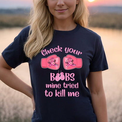 Teesdily | Check Your Boobs Mine Tries To Kill Me Shirt, Breast Cancer Sweatshirt, Cancer Awareness Pink Ribbon Hoodie Mug, Cancer Survivor Gifts