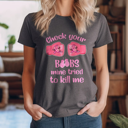 Teesdily | Check Your Boobs Mine Tries To Kill Me Shirt, Breast Cancer Sweatshirt, Cancer Awareness Pink Ribbon Hoodie Mug, Cancer Survivor Gifts