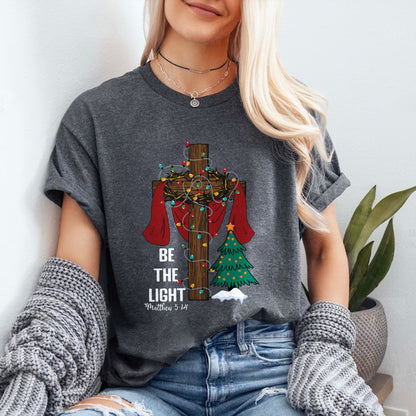 Teesdily | Be The Light Christmas Shirt, Jesus Cross Christmas Tree Sweatshirt, Christmas Family Hoodie Mug, Faith Religious Gift