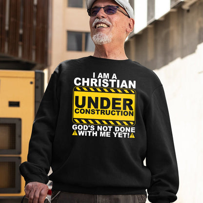 Teesdily | Christian Under Construction Graphic Shirt, God's Not Done With Me Yet Sweatshirt Hoodie Mug, Christian Gift Streetwear Clothing