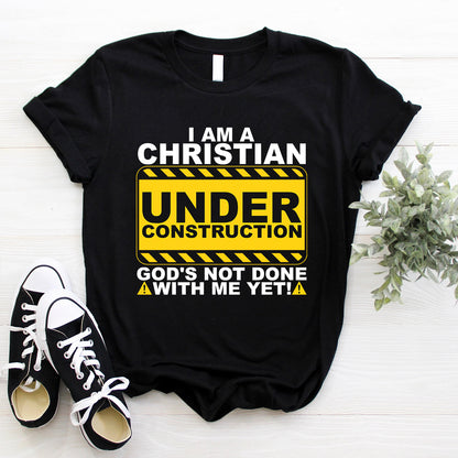 Teesdily | Christian Under Construction Graphic Shirt, God's Not Done With Me Yet Sweatshirt Hoodie Mug, Christian Gift Streetwear Clothing