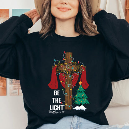 Teesdily | Be The Light Christmas Shirt, Jesus Cross Christmas Tree Sweatshirt, Christmas Family Hoodie Mug, Faith Religious Gift