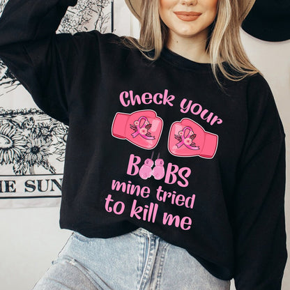 Teesdily | Check Your Boobs Mine Tries To Kill Me Shirt, Breast Cancer Sweatshirt, Cancer Awareness Pink Ribbon Hoodie Mug, Cancer Survivor Gifts