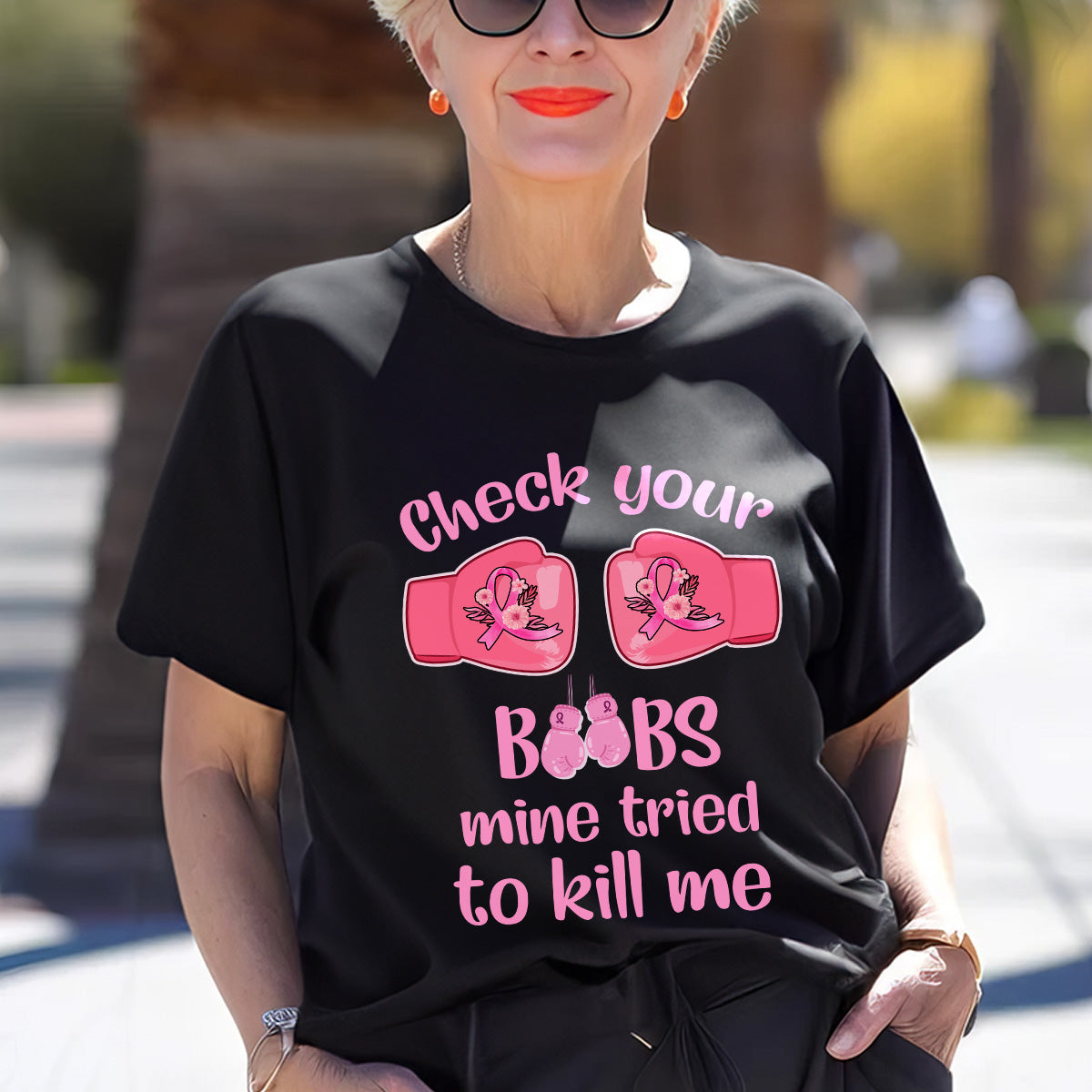 Teesdily | Check Your Boobs Mine Tries To Kill Me Shirt, Breast Cancer Sweatshirt, Cancer Awareness Pink Ribbon Hoodie Mug, Cancer Survivor Gifts