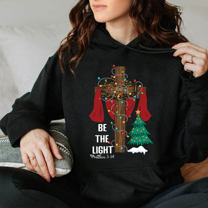 Teesdily | Be The Light Christmas Shirt, Jesus Cross Christmas Tree Sweatshirt, Christmas Family Hoodie Mug, Faith Religious Gift