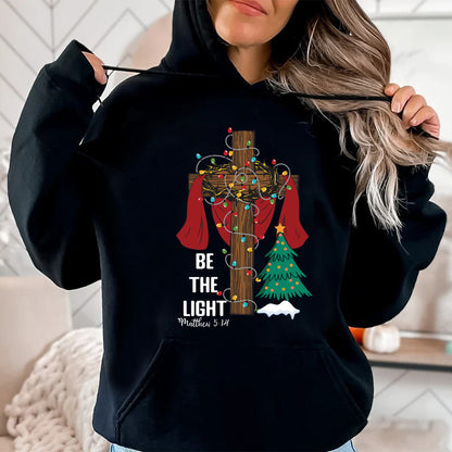 Teesdily | Be The Light Christmas Shirt, Jesus Cross Christmas Tree Sweatshirt, Christmas Family Hoodie Mug, Faith Religious Gift