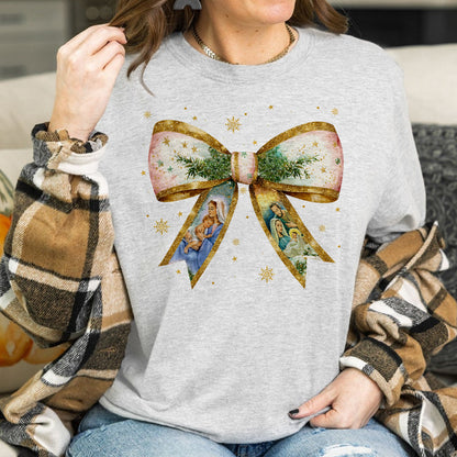 Teesdily | Jesus Christmas Coquette Bow Shirt, Christian Christmas Nativity Scene Sweatshirt, Bow Glitter Holy Family Hoodie Mug