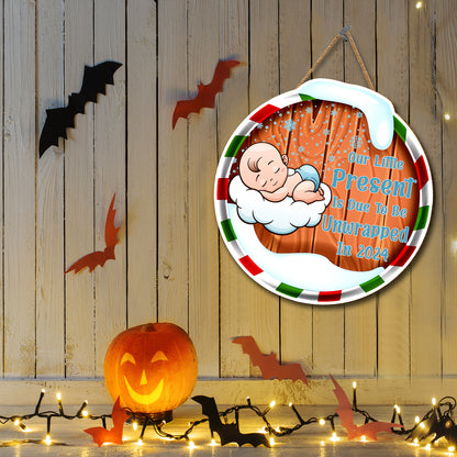 Teesdily | Christmas Round Hanging Sign, Our Little Present Is Due To Be Unwrapped In 2024 Sign, Pregnancy Christmas Door Decor, New Parents Gift Idea