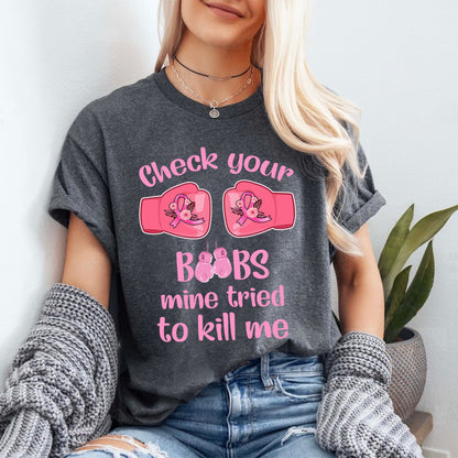 Teesdily | Check Your Boobs Mine Tries To Kill Me Shirt, Breast Cancer Sweatshirt, Cancer Awareness Pink Ribbon Hoodie Mug, Cancer Survivor Gifts