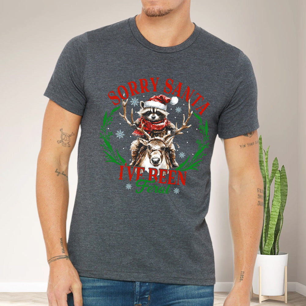 Teesdily | Sorry Santa I've Been Feral Shirt, Christmas Raccoon Shirt, Raccoon Santa Reindeer Sweatshirt Hoodie Mug, Family Gift